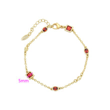 Load image into Gallery viewer, Gold bracelet with red gemstones on a white background.
